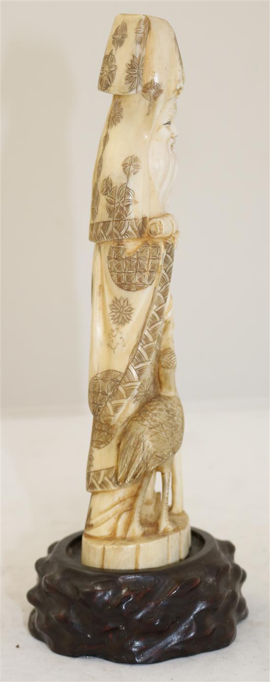 A Japanese walrus ivory figure of Fukurokuju, early 20th century, height 24.5cm incl. wood stand